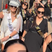 A bride to be in a crown walking with her group on a My Ultimate Hens day