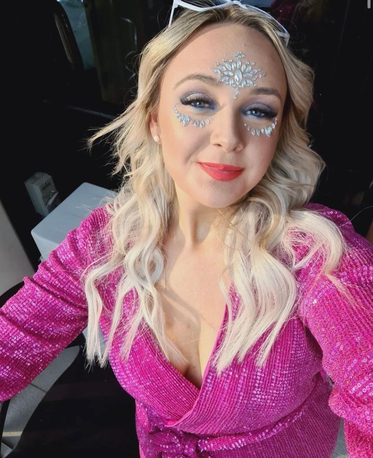 A hen with silver glitter face gems in a hot pink sequin jacket