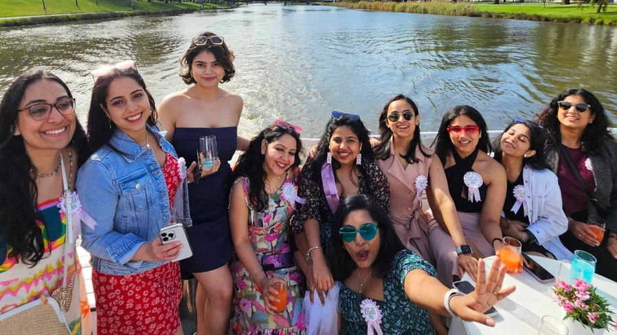 A big hens crew squeezed together on the deck of a river cruise in the sunshine