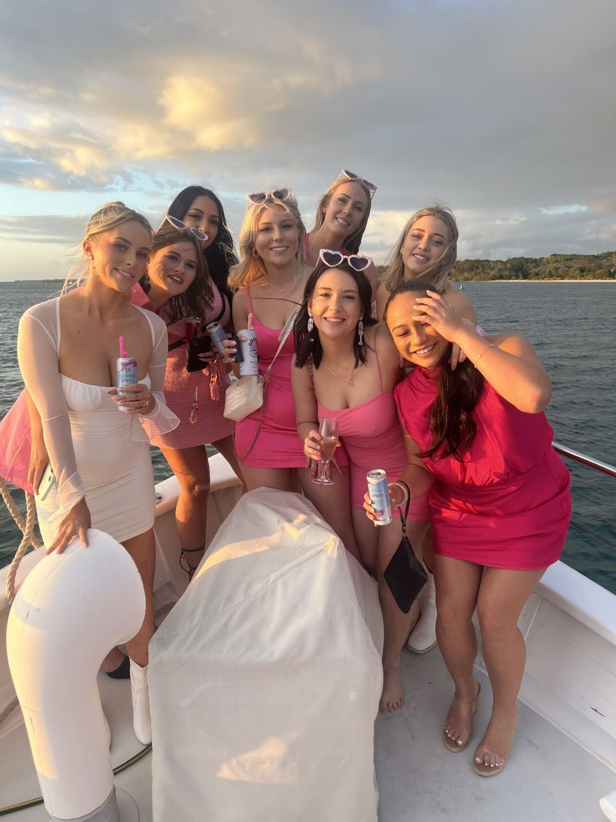 A hens group together on the deck of a boat at sunset