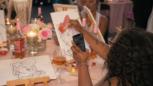A hens life drawing table with sketches and drinks