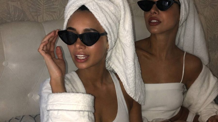 Two friends in white robes, towel turbans and cat-eye sunglasses