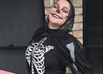 Britt mid twirl in a skeleton costume and face paint