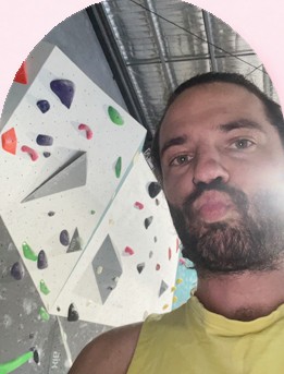 James pulling a pout for a selfie in front of an indoor climbing wall