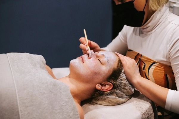 A guest relaxing with her eyes closed during a skin session