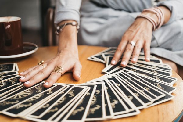 A lovely tarot card reader laying out the deck