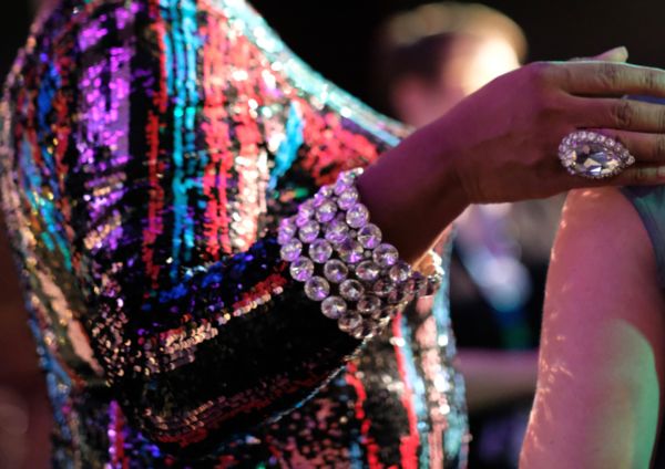 A gorgeous drag queen with sequins and oversized ring with bride to be