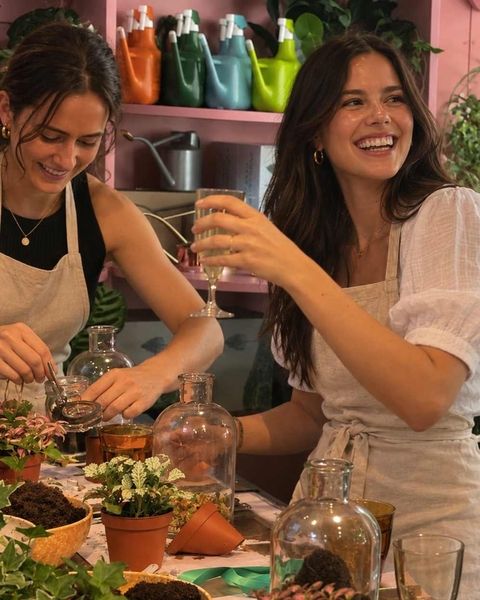 Two friends laughing as they make terrariums