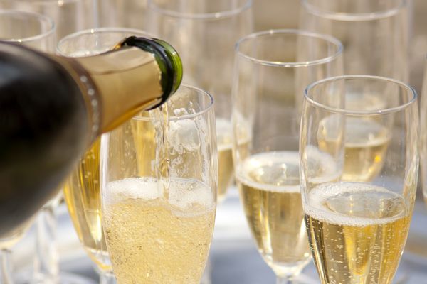 bubbly being poured into multiple flutes