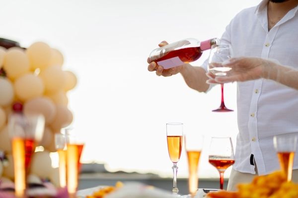 a rooftop bar at a hens with someone pouring champagne