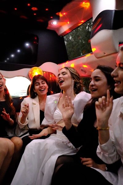 Friends laughing and dancing in a party bus