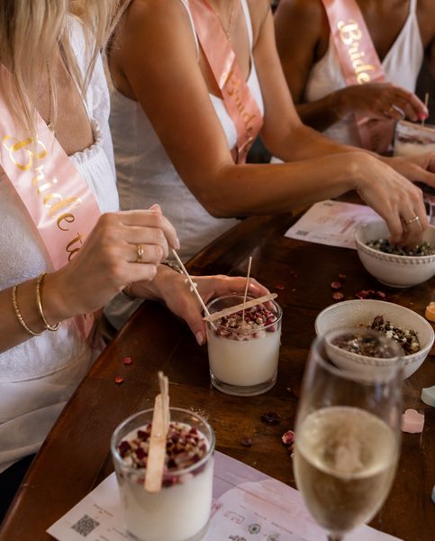 Hens in sashes decorating desserts at a table with bubbles