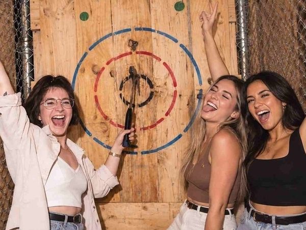 Three friends celebrating a bullseye together