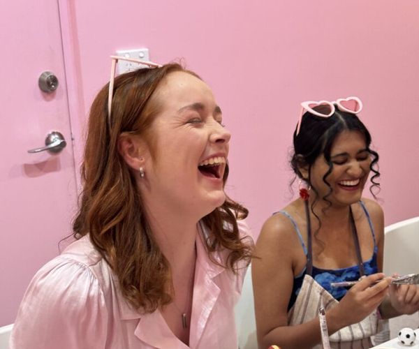 A friend in pink laughing her head off at the cheeky class table