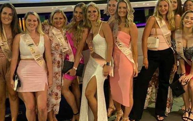 A hens group in pink and white lined up for a night out