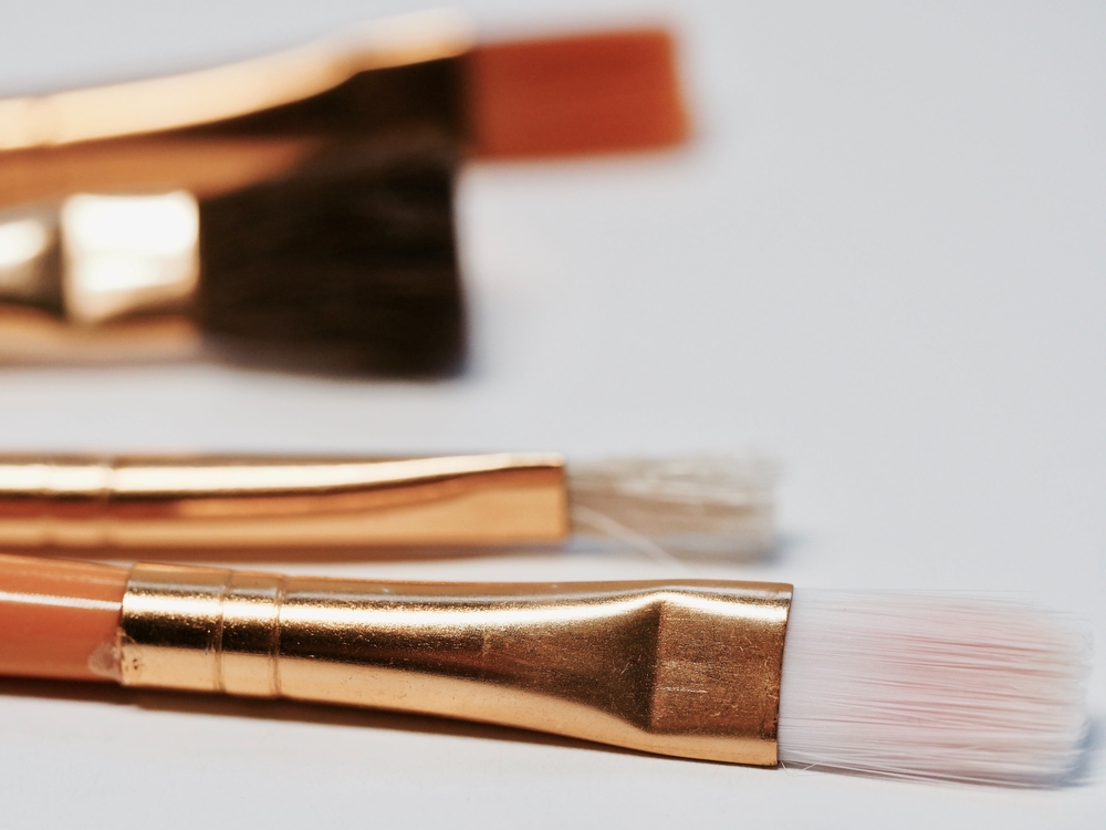 Paintbrushes with copper handles, close up