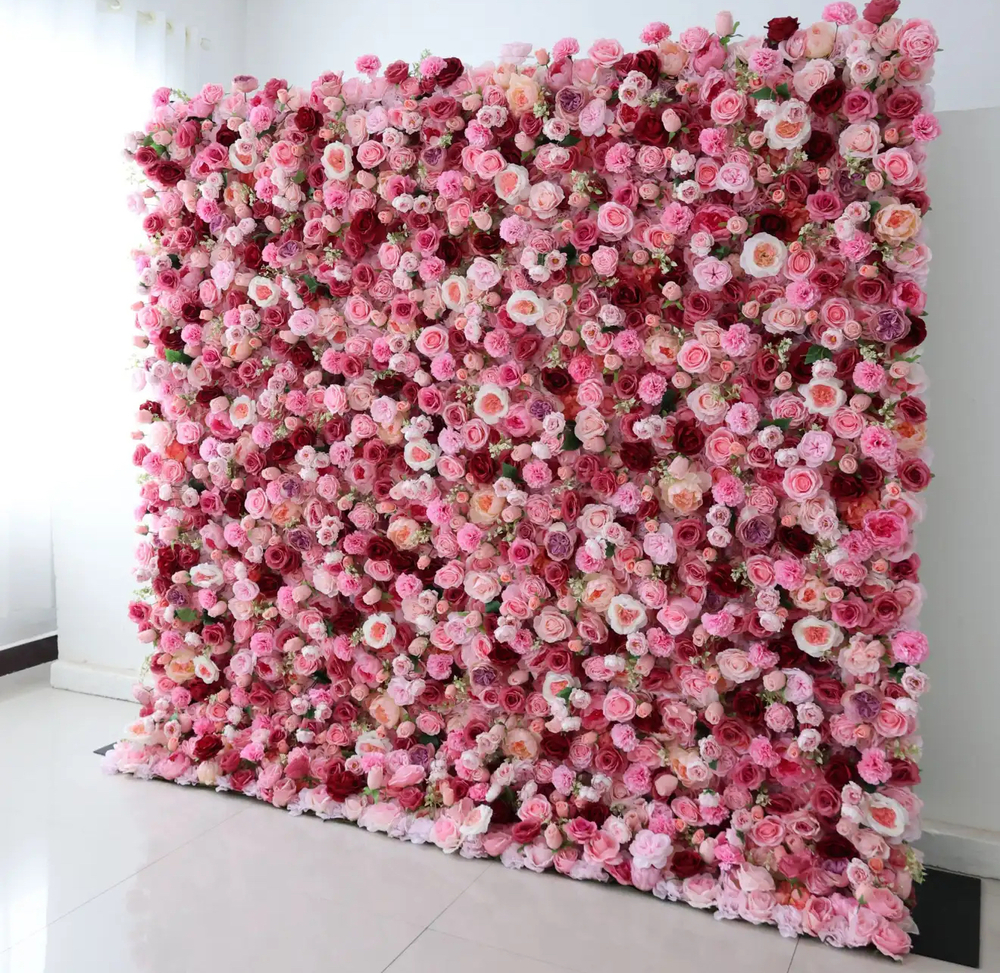 A wall covered in pink and red roses