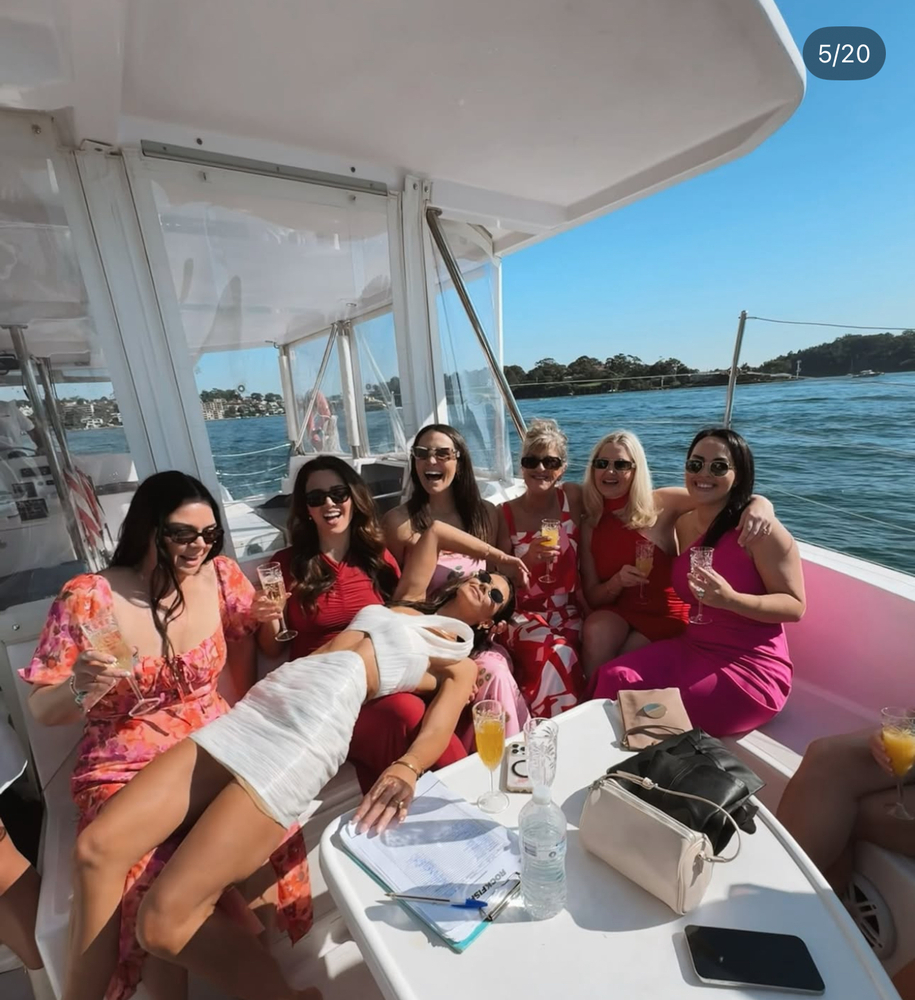 Britt stretched out across her friends on the catamaran's lounge, everyone laughing