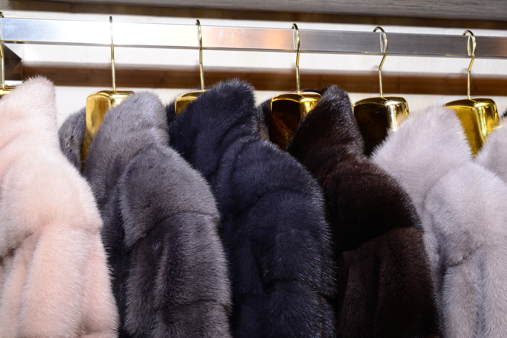 A rail of faux fur coats in cream, grey and brown