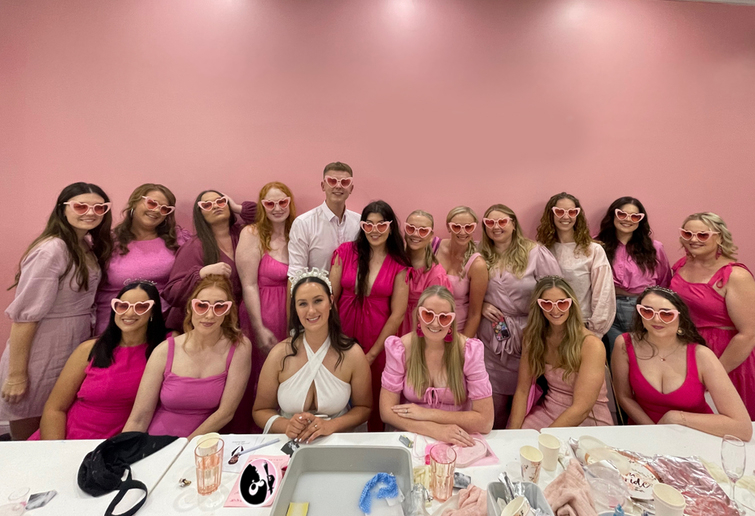 A big hens group in pink around a long studio table