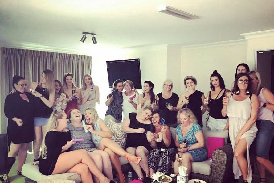 A big group of friends laughing together on lounges
