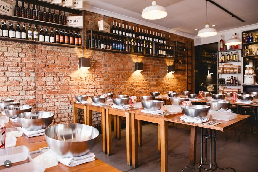 Timber class tables set with steel mixing bowls under warm pendant lights