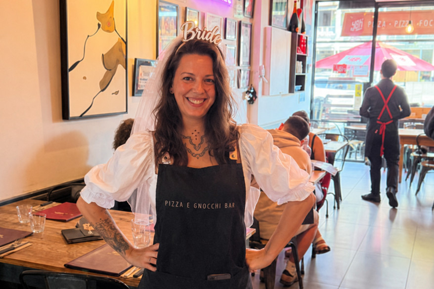 A bride to be in a Bride headband and apron smiling in a gnocchi bar before her class