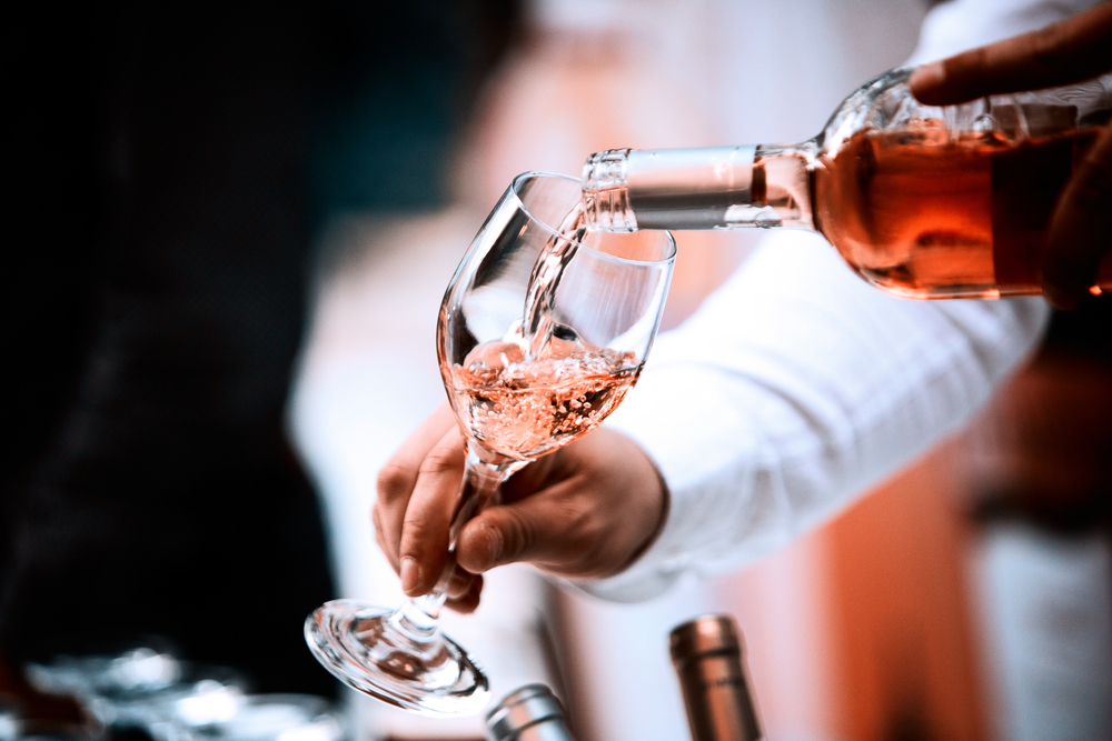 Rose being poured from the bottle into a tasting glass