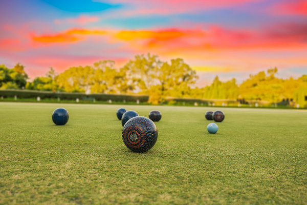 Barefoot bowls on the green at sunset